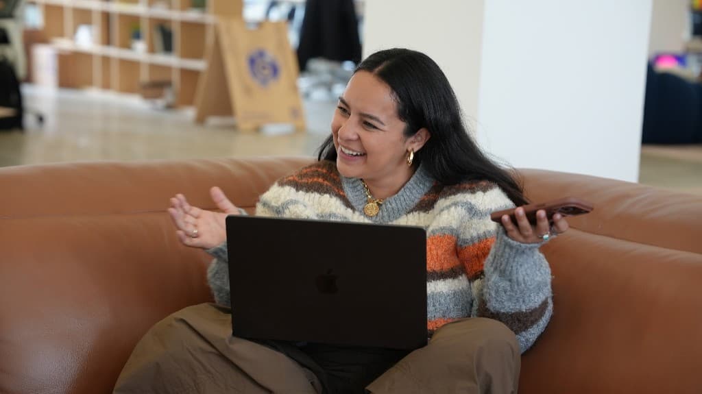 A Gumlooper laughing during a call from the office lounge
