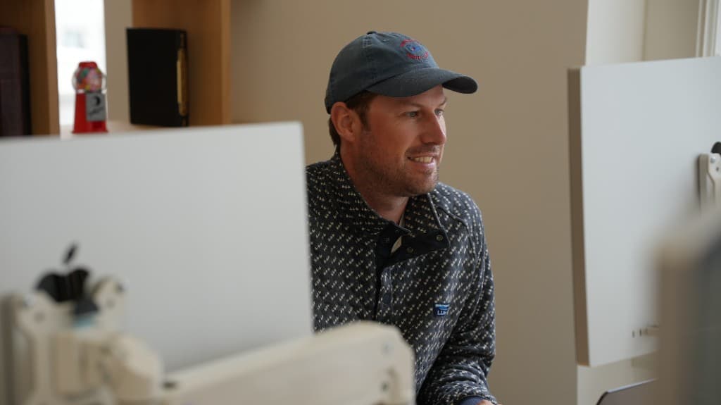 A Gumlooper heads-down at a dual-monitor workstation