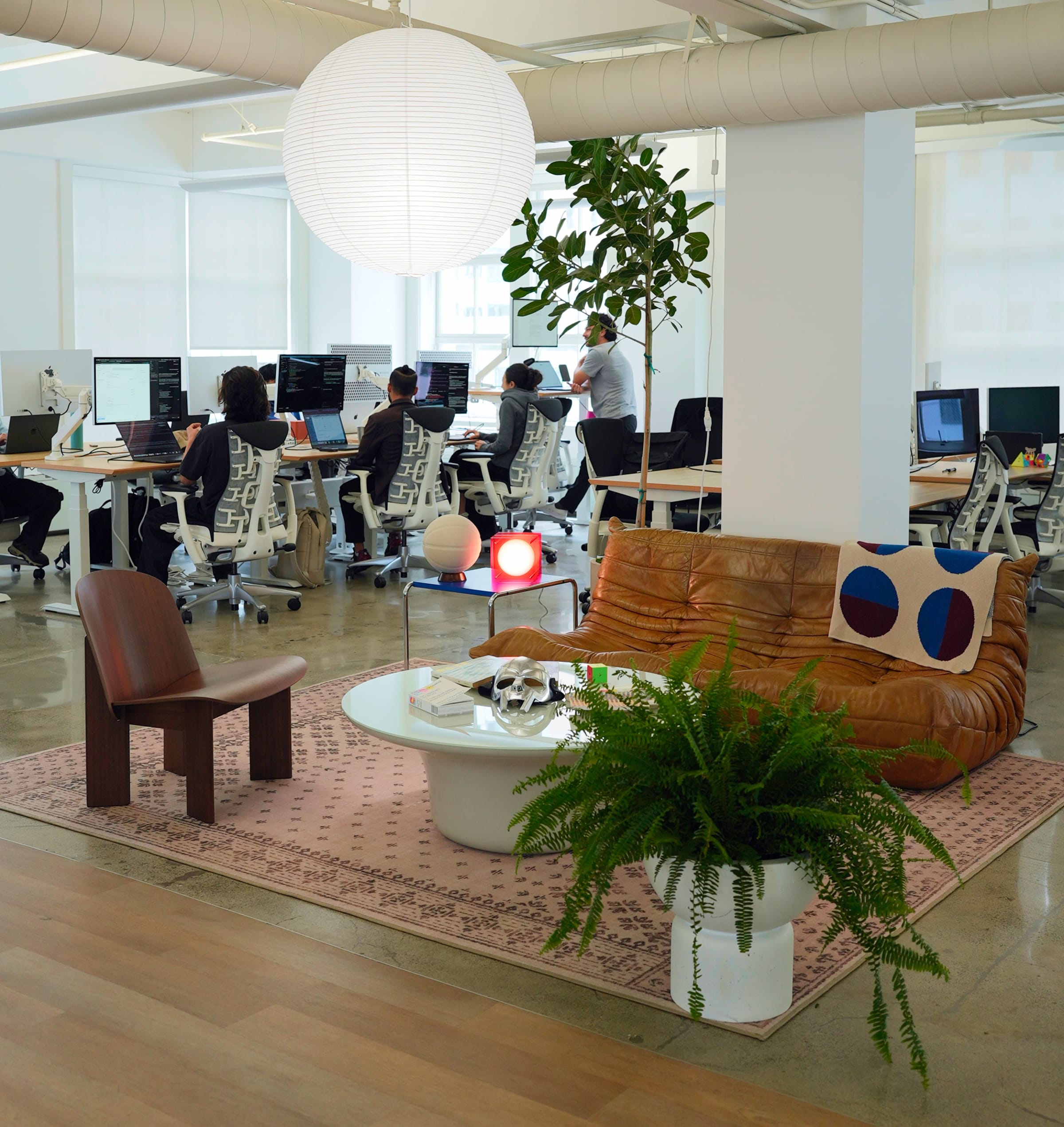The Gumloop office floor, with the team at their desks beside the lounge area